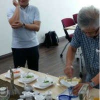 Older and younger participants sharing food at a table