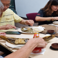 People of different generations sharing a meal at a community table